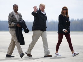 President Donald Trump, first lady Melania Trump and Secretary of Housing and Urban Development Ben Carson walk from Marine One to board Air Force One at Lawson Army Airfield, Fort Benning, Ga., Friday, March 8, 2019, en route Palm Beach International Airport in West Palm Beach, Fla., after visiting Lee County, Ala., where tornados killed 23 people.