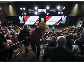 Bidders take their seats at the Calgary Stampede chuckwagon canvas auction in Calgary, Alta., Thursday, March 21, 2019.THE CANADIAN PRESS/Jeff McIntosh