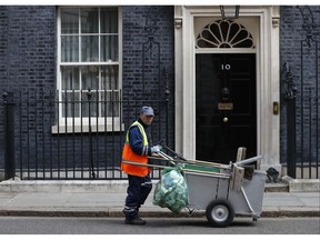 A street cleaner in Downing Street, London, Friday March 29, 2019. On the day that Britain was originally scheduled to leave the European Union, lawmakers will vote Friday on what Prime Minister Theresa May's government described as the "last chance to vote for Brexit."