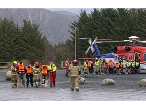 Passengers rescued from the Viking Sky cruise ship are helped from a helicopter in Hustadvika, Norway, Saturday March 23, 2019. A cruise ship with engine problems sent a mayday call off Norway's western coast on Saturday, then began evacuating its 1,300 passengers and crew amid stormy seas and heavy winds in a high-risk helicopter rescue operation.