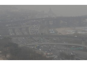 Vehicles move near the Han river in Seoul, South Korea, Tuesday, March 5, 2019. South Korean Environment Ministry issued emergency fine dust reduction measures on Tuesday.