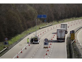 On the first day of Operation 'Brock', (Brexit Operations Across Kent) trucks pass through a contraflow system being tested on one side of the M20 motorway near Hollingbourne, Kent, in south east England, Monday, March 25, 2019. The contraflow is designed to manage queues of trucks heading to Europe, via ferries or the Eurotunnel to France, in the event of a no-deal Brexit, to prevent gridlock for other road users.