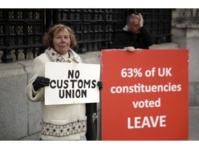 Pro-Brexit supporters protest outside the Houses of Parliament in London, Monday, March 18, 2019. British Prime Minister Theresa May was making a last-minute push Monday to win support for her European Union divorce deal, warning opponents that failure to approve it would mean a long -- and possibly indefinite -- delay to Brexit. Parliament has rejected the agreement twice, but May aims to try a third time this week if she can persuade enough lawmakers to change their minds.