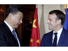 Chinese President Xi Jinping, left, is welcomed by French President Emmanuel Macron at the Villa Kerylos in Beaulieu-sur-Mer, southern France, Sunday, March, 24, 2019. Chinese President Xi Jinping is coming to Monaco and France amid mixed feelings in Europe about China's growing global influence.