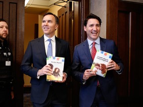 ustin Trudeau, Canada's prime minister, right, and Bill Morneau, Canada's finance minister, center, arrive at the House of Commons before tabling the federal budget in Ottawa.