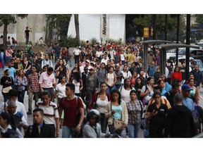 People spill out into an avenue after a power outage in Caracas, Venezuela, Thursday, March 7, 2019. A power outage left much of Venezuela in the dark early Thursday evening in what appeared to be one of the largest blackouts yet in a country where power failures have become increasingly common.