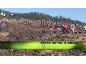 In this image taken from video, rescuers search through wreckage at the scene of an Ethiopian Airlines flight that crashed shortly after takeoff at Hejere near Bishoftu, or Debre Zeit, some 50 kilometers (31 miles) south of Addis Ababa, in Ethiopia Sunday, March 10, 2019. The Ethiopian Airlines flight crashed shortly after takeoff from Ethiopia's capital on Sunday morning, killing all 157 on board, authorities said, as grieving families rushed to airports in Addis Ababa and the destination, Nairobi.