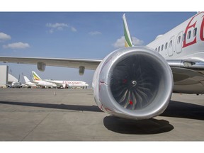 Other Ethiopian Airlines aircraft are seen in the distance behind an Ethiopian Airlines Boeing 737 Max 8 as it sits grounded at Bole International Airport in Addis Ababa, Ethiopia Saturday, March 23, 2019. The chief of Ethiopian Airlines says the warning and training requirements set for the now-grounded 737 Max aircraft may not have been enough following the Ethiopian Airlines plane crash that killed 157 people.