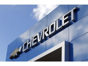 FILE - This April 26, 2017 file photo shows a Chevrolet sign at a Chevrolet dealership in Richmond, Va. Less than a week after a series of critical tweets from President Donald Trump over an Ohio plant closure, General Motors is announcing plans to add 400 jobs and build a new electric vehicle at a Michigan factory. The company said Friday, March 22, 2019,  it will spend $300 million in Orion Township to build a Chevrolet vehicle based on the battery-powered Bolt.