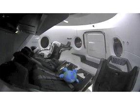 This photo provided by SpaceX shows a life-size test dummy along with a toy that is floating in the Dragon capsule as the capsule made orbit on Saturday, March 2, 2019.   America's newest capsule for astronauts rocketed toward the International Space Station on a high-stakes test flight by SpaceX.  This latest, flashiest Dragon is on a fast track to reach the space station Sunday morning, just 27 hours after liftoff.  (SpaceX via AP)