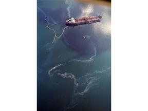 FILE - In this April 9, 1989, file photo, crude oil from the tanker Exxon Valdez, top, swirls on the surface of Alaska's Prince William Sound near Naked Island, days after the tanker ran aground, spilling millions of gallons of oil and causing widespread environmental damage.