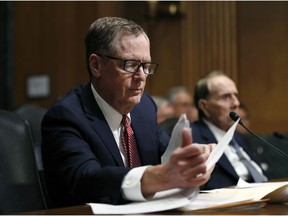FILE - In this March 14, 2017, file photo, United States Trade Representative-nominee Robert Lighthizer, foreground, looks at documents during his confirmation hearing on Capitol Hill in Washington.  Lighthizer, the top U.S. trade negotiator, suggests that the U.S. and China are nearing an agreement that would end their trade conflict, but wouldn't commit to a specific time frame. "Our hope is that we are in the final weeks of having an agreement," U.S. Trade Representative Lighthizer told the Senate Finance Committee.