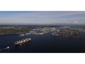 FILE- In this Tuesday, March 5, 2019, file photo the Cape Kortia container ship heads into the Port of Tacoma in Commencement Bay. The U.S. trade deficit jumped nearly 19 percent in December, pushing the trade imbalance for all of 2018 to widen to a decade-long high of $621 billion. The gap with China on goods widened to an all-time record of $419.2 billion.