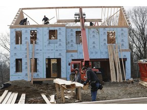 FILE- In this Jan. 4, 2019, file work continues on a plan of new homes in Franklin Park, Pa. On Thursday, March 7, the Labor Department issues revised data on productivity in the fourth quarter.