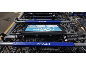 FILE- This June 15, 2017, file photo, shows Kroger grocery store shopping carts with the store's name in Flowood, Miss. Kroger reports financial results Thursday, March 7, 2019.