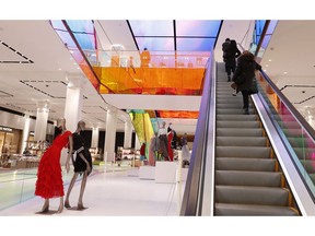 FILE- In this Feb. 20, 2019, file photo shoppers ride the escalator at Saks Fifth Avenue's flagship midtown Manhattan store in New York. On Friday, March 29, the Commerce Department issues its January report on consumer spending, which accounts for roughly 70 percent of U.S. economic activity.