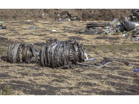FILE- In this March 11, 2019, file photo airplane parts lie on the ground at the scene of an Ethiopian Airlines flight crash near Bishoftu, or Debre Zeit, south of Addis Ababa, Ethiopia. Investigators have determined that an anti-stall system automatically activated before the Ethiopian Airlines Boeing 737 Max jet plunged into the ground, The Wall Street Journal reported Friday, March 29.