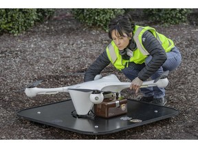 In this March 2019 photo provided by UPS, a drone operator handles a drone used for carrying medical specimens at a landing area at WakeMed hospital in Raleigh, N.C. UPS, Matternet and WakeMed announced a program on Tuesday, March 26, 2019, to use drones for commercial flights of blood samples and other medical specimens at the North Carolina hospital campus. (UPS via AP)