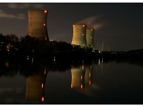 FILE - In this Nov. 2, 2006 file photo, cooling towers of the Three Mile Island nuclear power plant are reflected in the Susquehanna River in this time exposure photograph in Middletown, Pa. With nuclear power plant owners seeking a rescue in Pennsylvania, a number of state lawmakers are signaling that they are willing to help, with conditions. Giving nuclear power plants what opponents call a bailout could mean a politically risky vote to hike electric bills.