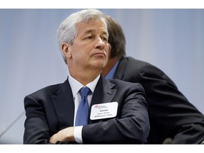 FILE - In this Dec. 3, 2014 file photo, JPMorgan Chase Chairman and CEO Jamie Dimon listens as President Barack Obama speaks to leading CEOs to discuss ways to promote the economy and create jobs during the president's last two years in office at the Business Roundtable Headquarters in Washington. The Business Roundtable, a lobbying organization of major companies' chief executives, said Wednesday, March 20, 2019 its first-quarter survey of CEOs showed strong support for Congress to create a new national law governing consumer data privacy.