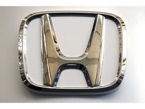 In this Feb. 14, 2019, photo, this photo shows the Honda logo on a sign at the 2019 Pittsburgh International Auto Show in Pittsburgh. Honda will be recalling about 1 million older vehicles in the U.S. and Canada because the Takata driver's air bag inflators that were installed during previous recalls could be dangerous. Documents posted Monday, March 11, 2019, by Canadian safety regulators show that Honda is recalling many of its most popular models for a second time.