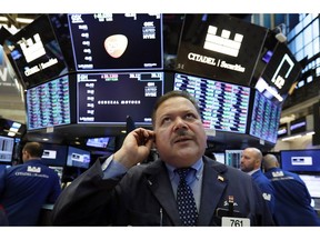 FILE- In this March 18, 2019, file photo trader John Santiago works on the floor of the New York Stock Exchange. U.S. stocks edged lower in early trading Monday, March 25, extending losses from a broad sell-off last week, as new economic data stoked investors' worries over slowing global growth.