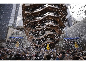 Confetti swirls around "Vessel" on its opening day at Hudson Yards, Friday, March 15, 2019, in New York. Hudson Yards, a $25 billion urban complex on Manhattan's west side, is the city's most ambitious development since the rebuilding of the World Trade Center. When fully complete, the 28-acre site will include 16 towers of homes and offices, a hotel, a school, the highest outdoor observation deck in the Western Hemisphere, a performing arts center, Vessel and a shopping mall.