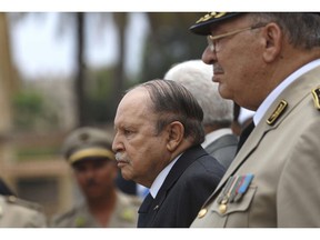 In this picture taken on June 27, 2012, Algerian President Abdelaziz Bouteflika, left, and his Army chief of staff, Gen. Ahmed Gaid Salah, review an honor guard before attending a military parade, in Cherchell near Algiers, Algeria. Algeria's powerful army chief, Ahmed Gaid Salah, insisted Wednesday that the military won't get mixed up in politics, a day after he said a constitutional process should be set in motion to declare ailing President Abdelaziz Bouteflika unfit for office.