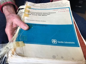 In this March 5, 2019 photo, Don Hancock of the Southwest Research and Information Center holds an early draft copy of an environmental review related to the Waste Isolation Pilot Plant that was planned for southern New Mexico. The underground nuclear repository has been in operation for 20 years, having received its first shipment of waste on March 26, 1999.
