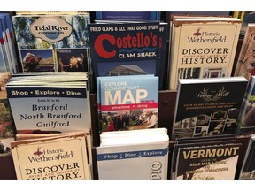 In this Friday, March 29, 2019 photo, pamphlets from various Connecticut tourism attractions are displayed on a rack at the Courtyard Marriott hotel in Norwich, Conn. Lawmakers are considering whether to devote more resources to boost tourism in Connecticut after years of tight budgets. Ideas include devoting more hotel tax revenue for tourism promotion and reopening or expanding the hours of the state visitor welcome centers. There's also a call for overhauling the state's slogan, "Connecticut: Still Revolutionary."