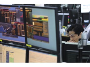 A currency trader watches monitors at the foreign exchange dealing room of the KEB Hana Bank headquarters in Seoul, South Korea, Friday, March 29, 2019. Asian markets were mostly higher on Friday as U.S. and Chinese officials kicked off a fresh round of trade talks in Beijing.