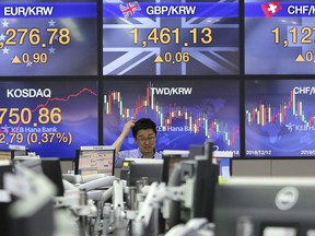 A currency trader watches monitors at the foreign exchange dealing room of the KEB Hana Bank headquarters in Seoul, South Korea, Tuesday, March 5, 2019. Shares have declined in most Asian markets, tracking an overnight sell-off on Wall Street.