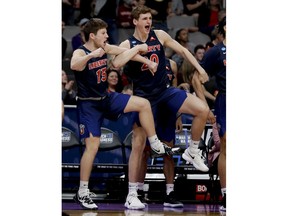 Liberty's Zach Farquhar, left, and Keegan McDowell celebrate during the second half of a first round men's college basketball game against Mississippi State in the NCAA tournament Friday, March 22, 2019, in San Jose, Calif.