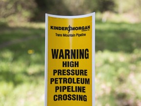 A sign where buried pipelines are located is seen in Burnaby B.C., just outside the Kinder Morgan location Thursday, April 26, 2018.