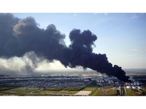 A plume of smoke rises from a petrochemical fire at the Intercontinental Terminals Company Monday, March 18, 2019, in Deer Park, Texas. The large fire at the Houston-area petrochemicals terminal will likely burn for another two days, authorities said Monday, noting that air quality around the facility was testing within normal guidelines.