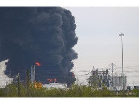 Firefighters battle a petrochemical fire at the Intercontinental Terminals Company Monday, March 18, 2019, in Deer Park, Texas. The fire will likely burn for another two days, authorities said Monday.