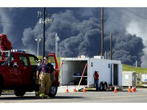 Firefighters arrive at the site where the Intercontinental Terminals Company petrochemical fire reignited, Friday, March 22, 2019, in Deer Park, Texas.  The efforts to clean up a Texas industrial plant that burned for several days this week were hamstrung Friday by a briefly reignited fire and a breach that led to chemicals spilling into the nearby Houston Ship Channel.