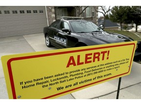 A warning sign and a police officer's vehicle are stationed at Walt Gilmore's home on Thursday, March 21, 2019. The Utah family has become the victim of extreme stalking involving unwanted service providers repeatedly being sent to their home, according to the homeowner and police.