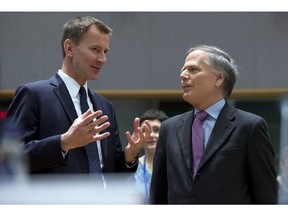 British Foreign Secretary Jeremy Hunt, left, speaks with Italian Foreign Minister Enzo Moavero Milanesi during a meeting of EU foreign ministers at the EU Council building in Brussels, Monday, March 18, 2019. EU foreign ministers hold talks with their Chinese counterpart as the bloc seeks to establish a new strategic balance with the Asian economic giant.