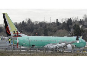 In this photo taken Monday, March 11, 2019, a Boeing 737 MAX 8 airplane being built for Air Canada sits parked at Boeing Co.'s Renton Assembly Plant in Renton, Wash.  Britain, France and Germany on Tuesday joined a rapidly growing number of countries grounding the new Boeing plane involved in the Ethiopian Airlines disaster or turning it back from their airspace, while investigators in Ethiopia looked for parallels with a similar crash just five months ago.