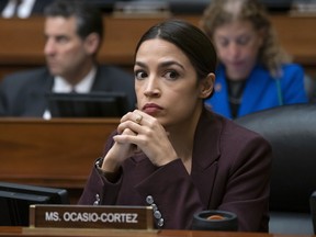 In this Feb. 27, 2019, photo, Rep. Alexandria Ocasio-Cortez, D-N.Y., listens to questioning of Michael Cohen on Capitol Hill in Washington. Ocasio-Cortez and several of her allies were accused this week by a conservative group of improperly masking political spending during the 2018 campaign.