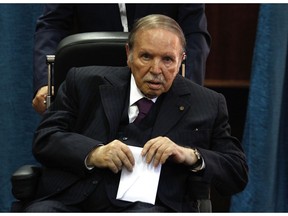 FILE - In this May 4, 2017 file photo, Algerian President Abdelaziz Bouteflika prepares to vote in Algiers.  Algeria, a gas-rich African giant and crucial western ally nearly brought to its knees in the 1990s by a bloody Islamist insurgency, is at a new turning point, this time led by citizens young and old peacefully protesting a bid for a fifth term by ailing President Abdelaziz Bouteflika.