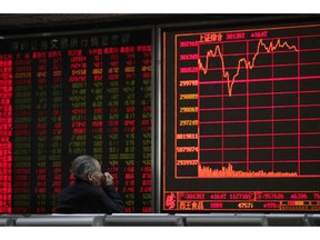 An investor monitors share prices at a brokerage house in Beijing, Wednesday, March 27, 2019. Shares were mixed in Asia early Wednesday after U.S. stocks finished broadly higher on Wall Street, erasing modest losses from a day earlier.