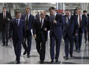 Russian President Vladimir Putin, center, visits a new power plant in Crimea, part of Moscow's efforts to upgrade the region's infrastructure in Sevastopol, Crimea, Monday, March 18, 2019. Putin visited Crimea to mark the fifth anniversary of Russia's annexation of Crimea from Ukraine by visiting the Black Sea peninsula.