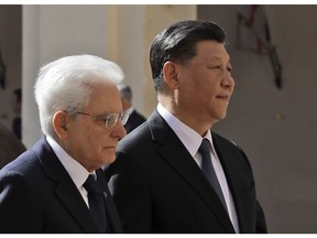 Chinese President Xi Jinping, right, and Italian President Sergio Mattarella review the honor guard at the Quirinale Presidential Palace, in Rome, Friday, March 22, 2019. Jinping is launching a two-day official visit aimed at deepening economic and cultural ties with Italy through an ambitious infrastructure building program called "Belt and Road" that has raised suspicions among Italy's U.S. and European allies.