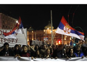 People march during a protest in Belgrade, Serbia, Saturday, March 16, 2019. Thousands of people have rallied in Serbia's capital for 15th week in a row against populist President Aleksandar Vucic and his government.