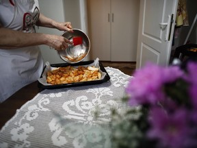 Jelena Petrovic prepares the food in her home in Jagodina, Serbia, Tuesday, Feb. 12, 2019. Serbs looking for ideas are increasingly turning to the Balkan country's hit chef Granny Jela, an elderly lady who has put her life-long experience to good use and launched an online cooking tutorial. Jelena Petrovic's YouTube channel and blog dubbed Granny's Kitchen have had over 50 million of views and nearly 150,000 subscribers who check in daily for a new recipe of home-made food.