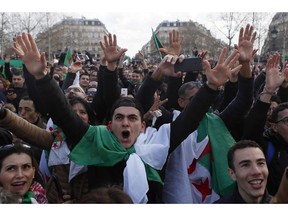 Demonstrators stage a protest to denounce President Abdelaziz Bouteflika's bid for a fifth term on Place de la Republique in Paris, Sunday, March 10, 2019. The protesters are challenging Bouteflika's fitness to run for a fifth term in next month's election.