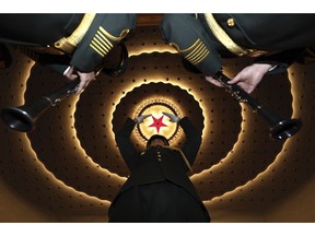 A military band conductor rehearses the band before the closing session of the National People's Congress in Beijing's Great Hall of the People on Friday, March 15, 2019.