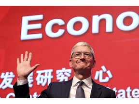 Apple CEO Tim Cook waves as he arrives for the Economic Summit held for the China Development Forum in Beijing, China, Saturday, March 23, 2019. Cook says he's "extremely bullish" about the global economy based on the amount of innovation being carried out, and he's urging China to continue to "open up."